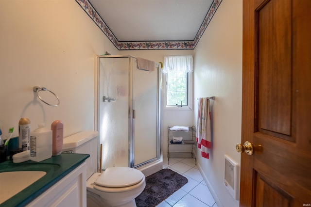 bathroom featuring tile patterned floors, toilet, a shower with door, and vanity