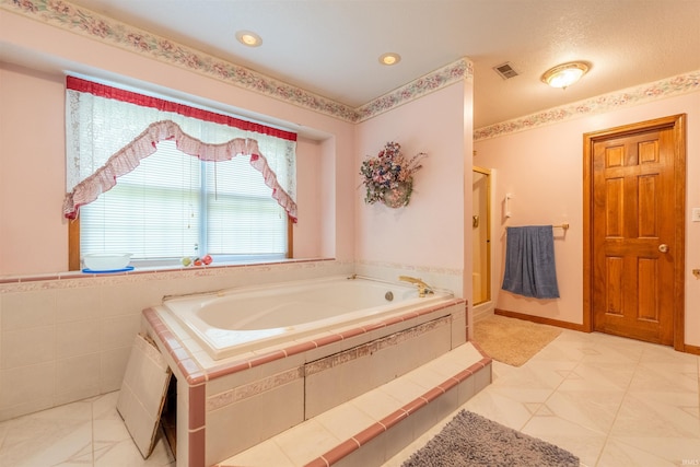 bathroom with tile patterned flooring and independent shower and bath