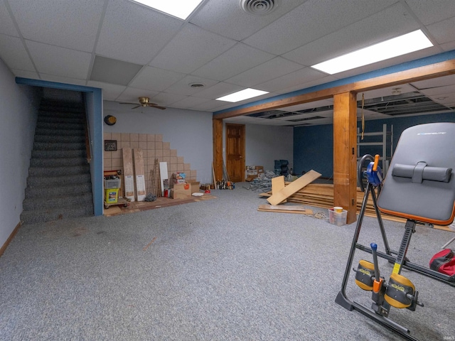 basement featuring a paneled ceiling and carpet flooring