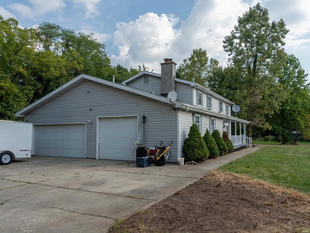 view of side of property with a yard and a garage