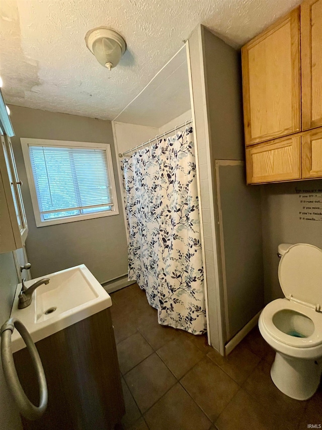 bathroom featuring tile patterned floors, a shower with curtain, toilet, and a textured ceiling