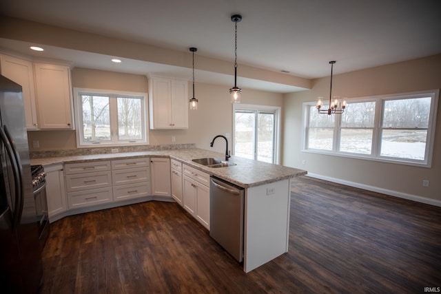 114 Meadow Ct, Argos, IN 46501 - kitchen featuring dishwasher, a sink, a peninsula, dark wood-type flooring, and white cabinetry