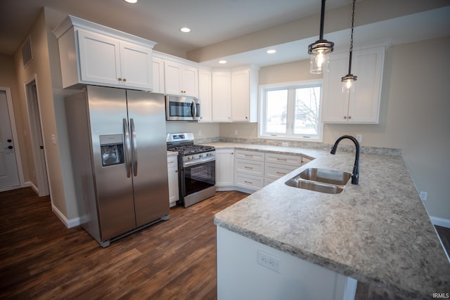 114 Meadow Ct, Argos, IN 46501 - kitchen with stainless steel appliances, a sink, a peninsula, dark wood-style flooring, and white cabinets