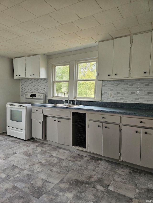 kitchen with white range with electric stovetop, wine cooler, sink, and decorative backsplash