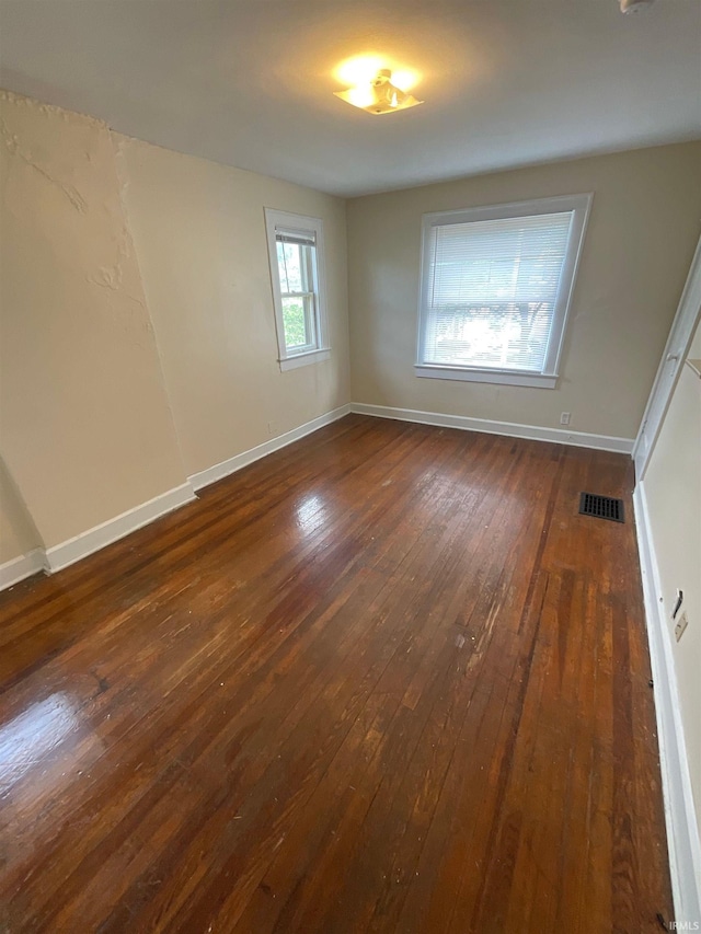 unfurnished room with dark hardwood / wood-style floors