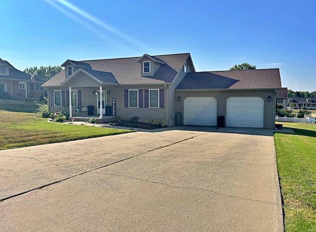 view of front of house featuring a garage and a front lawn