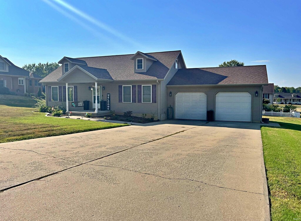 7 White Ridge Ct, Washington, IN 47501 - view of front of house featuring a shingled roof, a garage, a front yard, and driveway