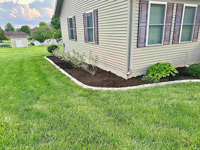 view of home's exterior featuring a yard and a shed