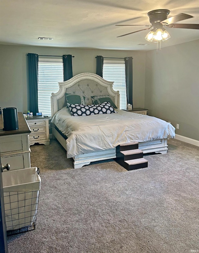 carpeted bedroom with multiple windows and ceiling fan