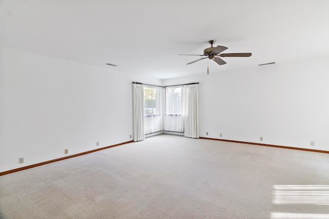 spare room with carpet flooring, a baseboard heating unit, and ceiling fan