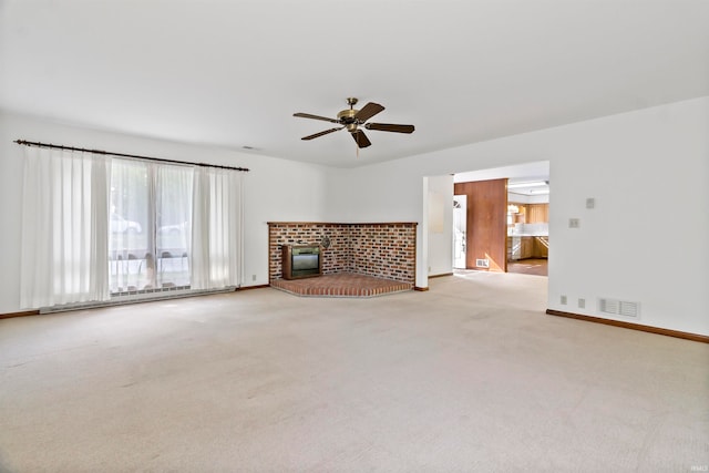 unfurnished living room with a baseboard radiator, ceiling fan, light carpet, and a brick fireplace