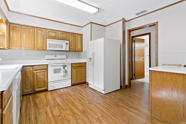 kitchen featuring light wood-type flooring, white appliances, ornamental molding, and sink