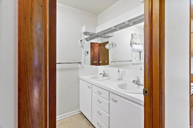 bathroom with vanity and ornamental molding