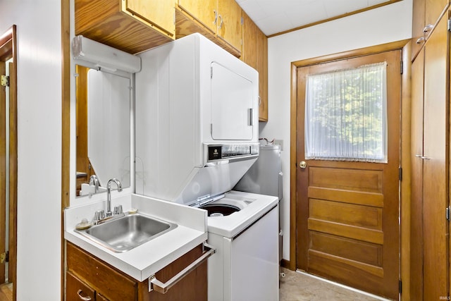 washroom with stacked washer and clothes dryer and sink