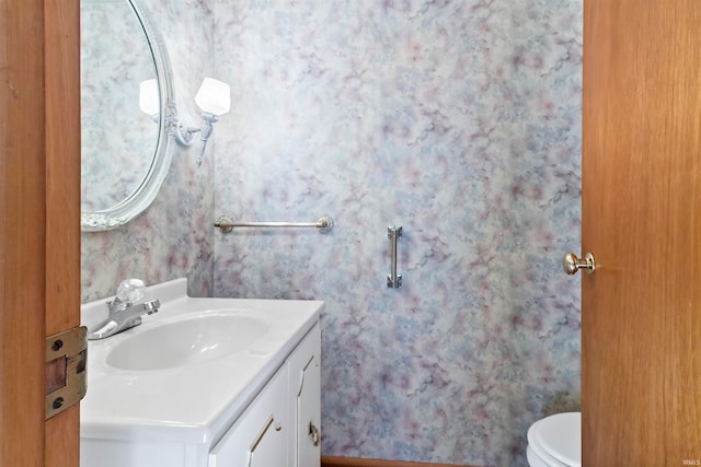 bathroom featuring vanity and toilet