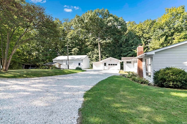 exterior space featuring a garage and a front lawn