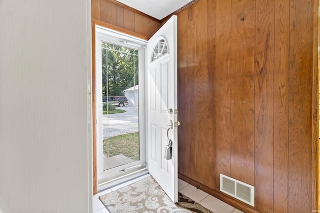 tiled foyer with wooden walls