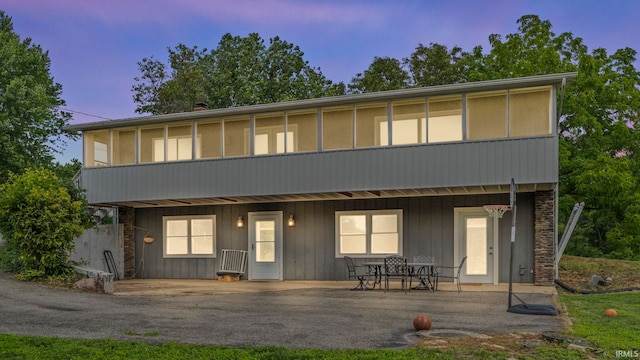 back house at dusk with a patio