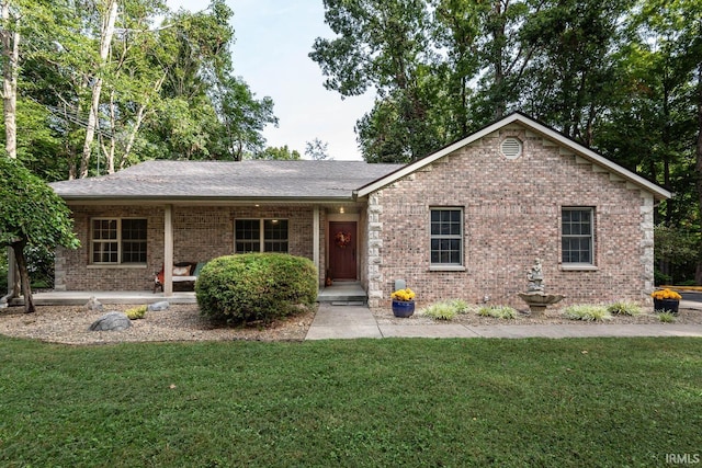 ranch-style home featuring a front yard