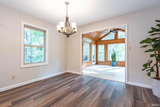 unfurnished room featuring ceiling fan with notable chandelier, lofted ceiling, a wealth of natural light, and dark hardwood / wood-style floors