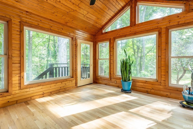 unfurnished sunroom featuring vaulted ceiling and a healthy amount of sunlight