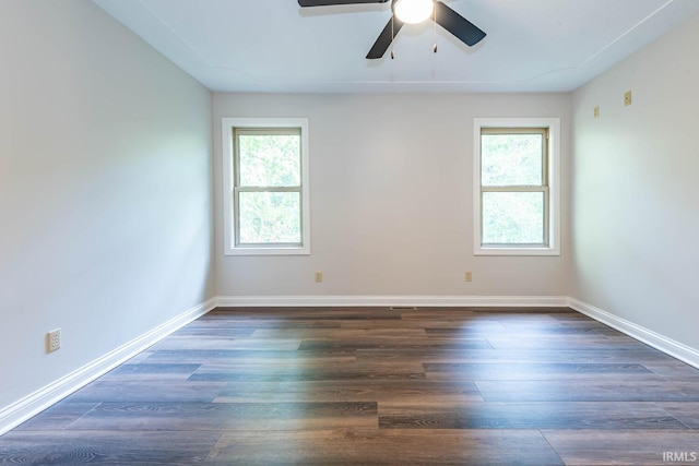 unfurnished room with dark hardwood / wood-style flooring, a healthy amount of sunlight, and ceiling fan