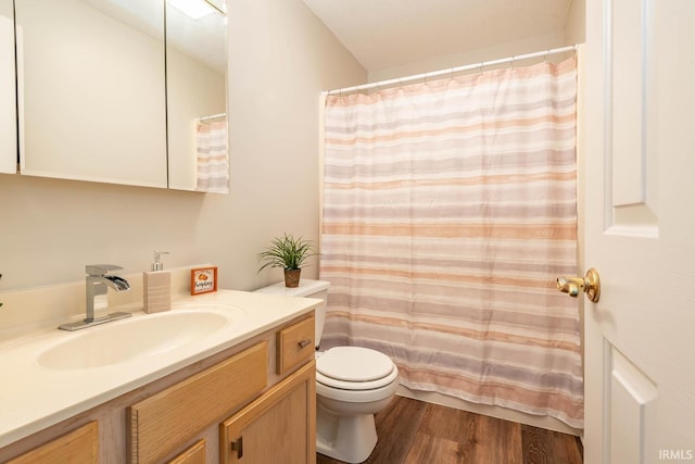 bathroom with vanity, toilet, a shower with curtain, and hardwood / wood-style flooring