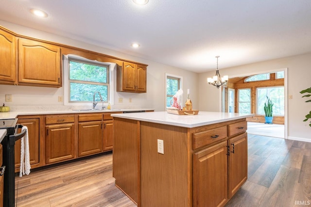 kitchen featuring plenty of natural light, a center island, a notable chandelier, and light hardwood / wood-style floors