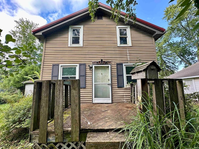 back of property with a wooden deck