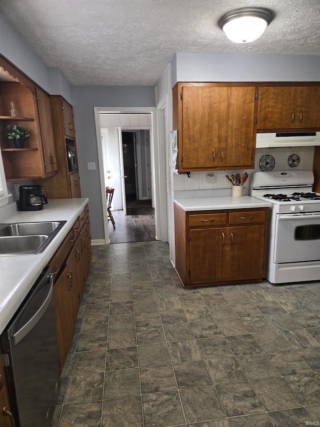 kitchen with dishwasher, white gas range, and a textured ceiling