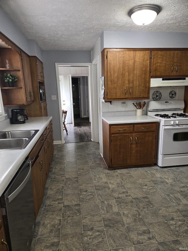 kitchen with white range with gas cooktop, dishwasher, light countertops, under cabinet range hood, and open shelves