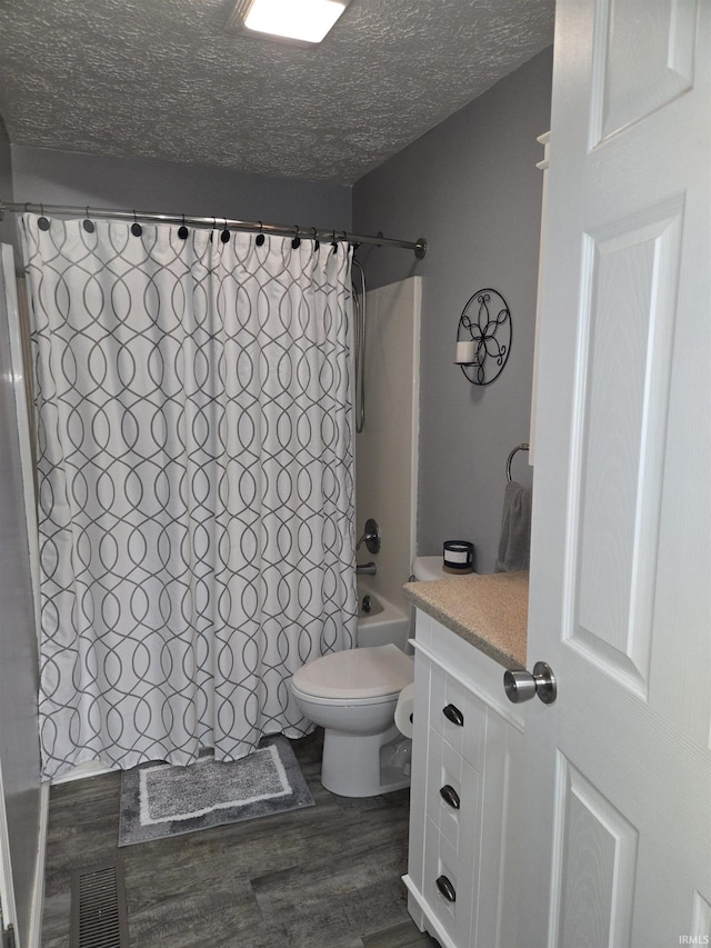 full bath featuring visible vents, toilet, wood finished floors, shower / bathtub combination with curtain, and a textured ceiling