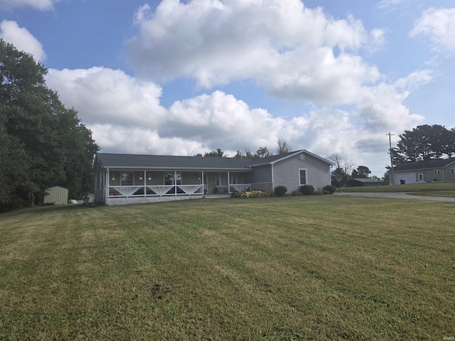 view of front of house featuring a sunroom and a front yard