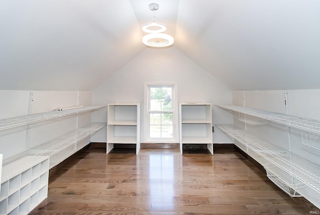 interior space featuring dark hardwood / wood-style flooring and lofted ceiling