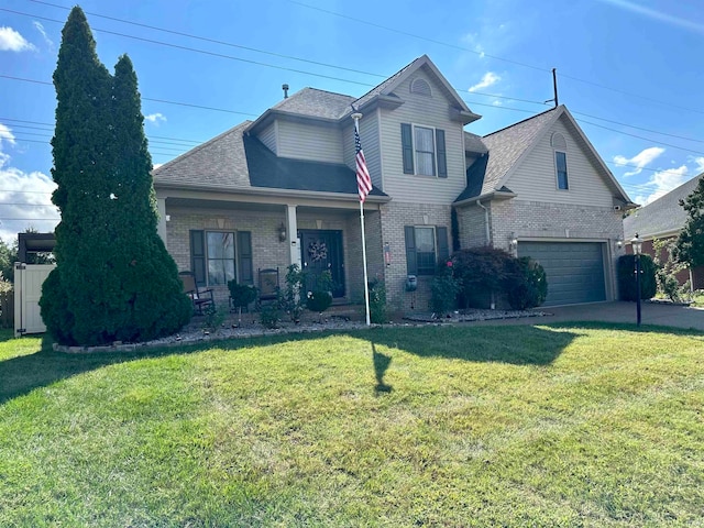 front of property featuring a garage, a front lawn, and covered porch