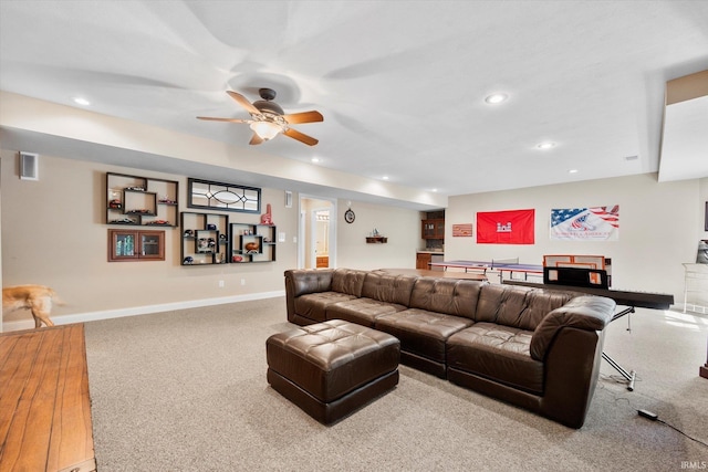 carpeted living room with ceiling fan