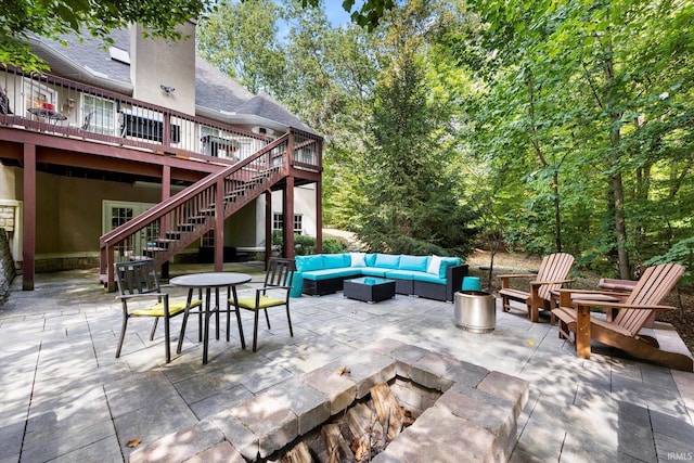 view of patio / terrace featuring an outdoor living space with a fire pit and a deck