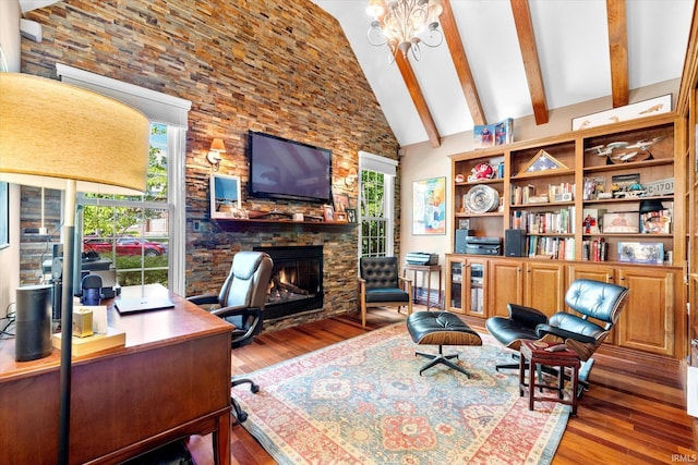 home office featuring an inviting chandelier, a fireplace, beam ceiling, high vaulted ceiling, and hardwood / wood-style flooring