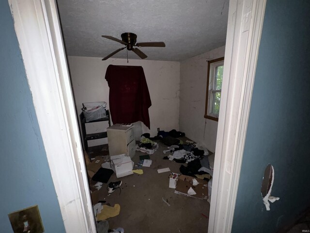 bedroom featuring a textured ceiling and ceiling fan