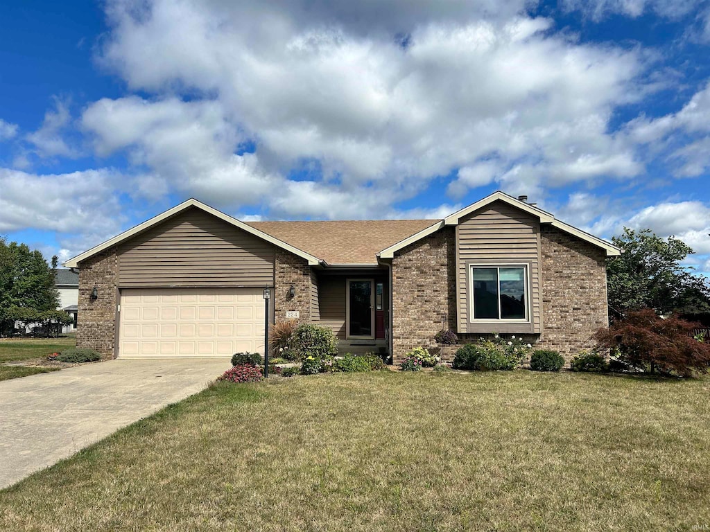 ranch-style house featuring a front lawn and a garage