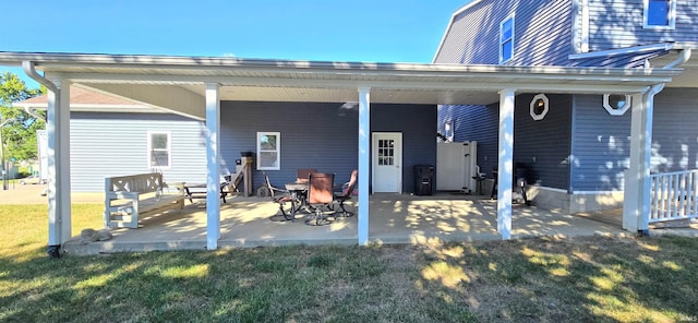 back of property featuring a yard and a patio