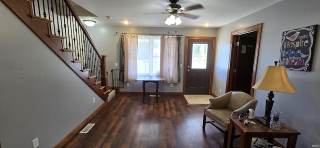 entryway with visible vents, stairway, ceiling fan, wood finished floors, and baseboards