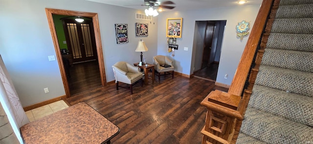 living room featuring ceiling fan and dark hardwood / wood-style floors