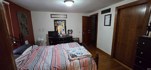 bedroom with dark wood-type flooring