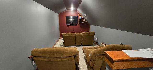 home theater room featuring lofted ceiling and carpet floors