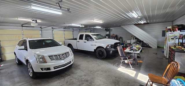 garage featuring a garage door opener and metal wall