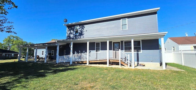 back of house featuring a porch, a lawn, and fence