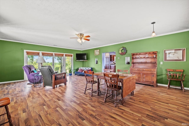 dining room featuring ceiling fan, wood-type flooring, and ornamental molding