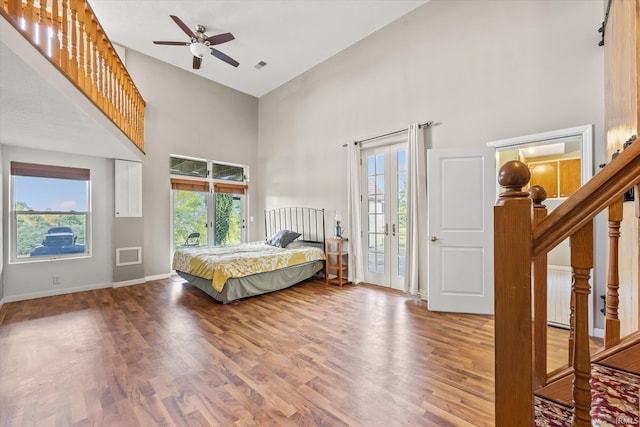 bedroom featuring multiple windows, ceiling fan, and hardwood / wood-style floors