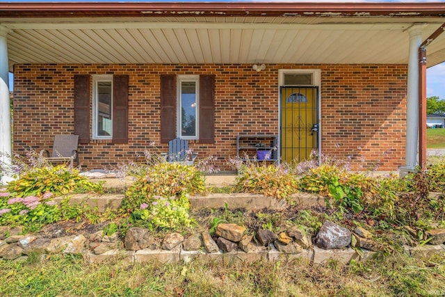 view of exterior entry featuring a porch